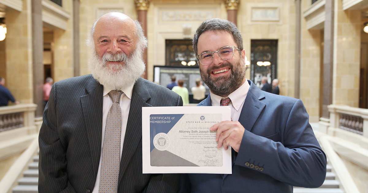 Seth Bichler (right), a new Wisconsin lawyer, poses with his father, attorney Howard Bichler,