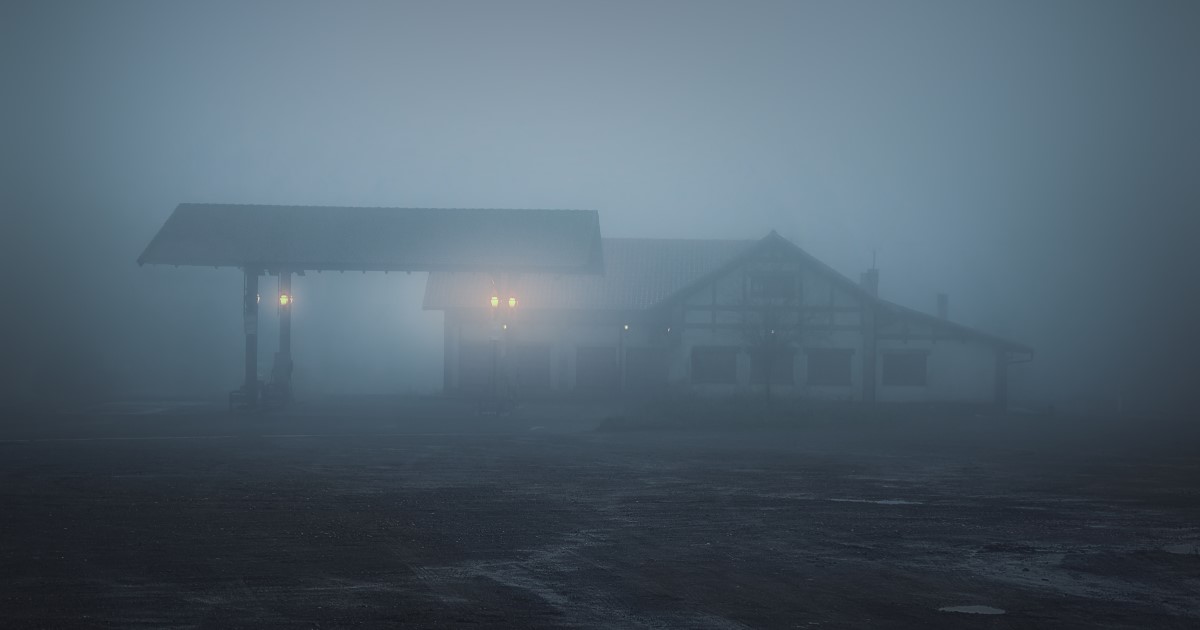 Spooky building in dense fog