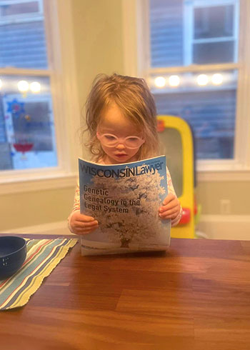 Child reading Wisconsin Lawyer magazine