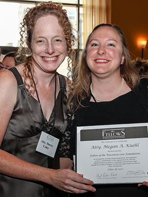 Megan Kuehl, left, shows her certificate, with Sherry Coley