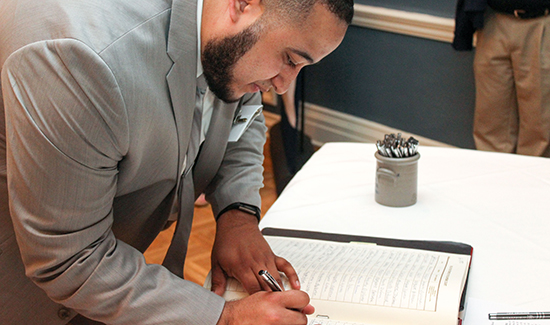 Nicholas Ramos signs the Supreme Court Roll book