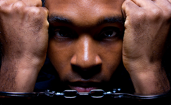 young african-american male in handcuffs