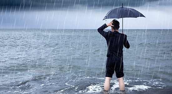 distressed businessman standing in storm water