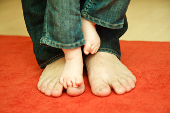 father and baby feet