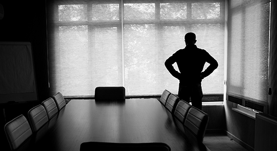 silhouette of business person at conference table