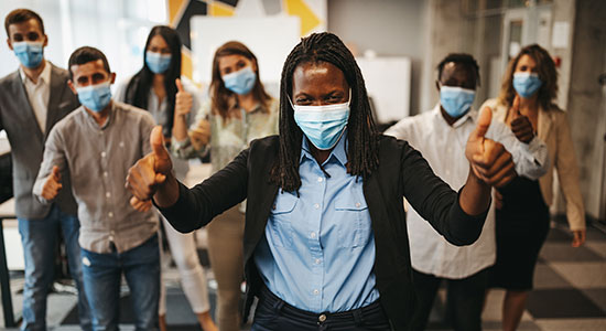 happy employees wearing facemasks