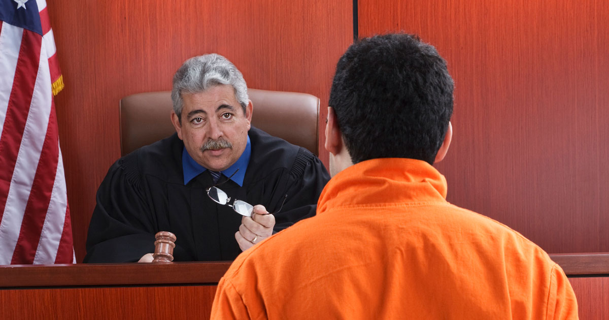 judge talks to defendent from the bench at trial