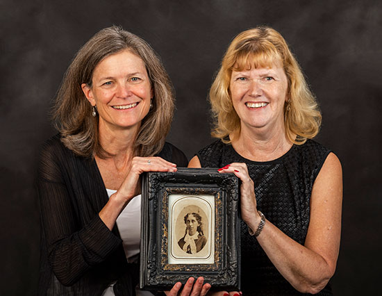 Colleen Ball and Nancy Kopp with portrait of Lavinia Goodell
