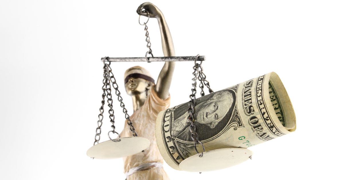statue of justice holds scales with dollar on it