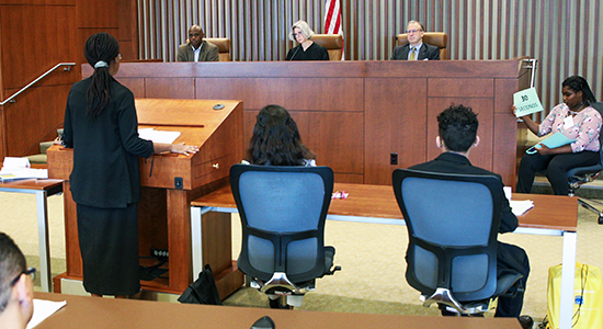 Judge Pamela Pepper listens to a student during oral arguments