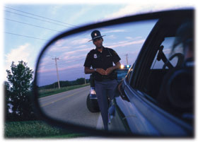 officer in rear view mirror