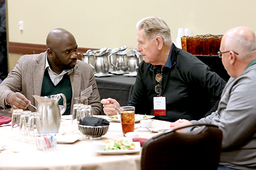 Speakers talking around a table