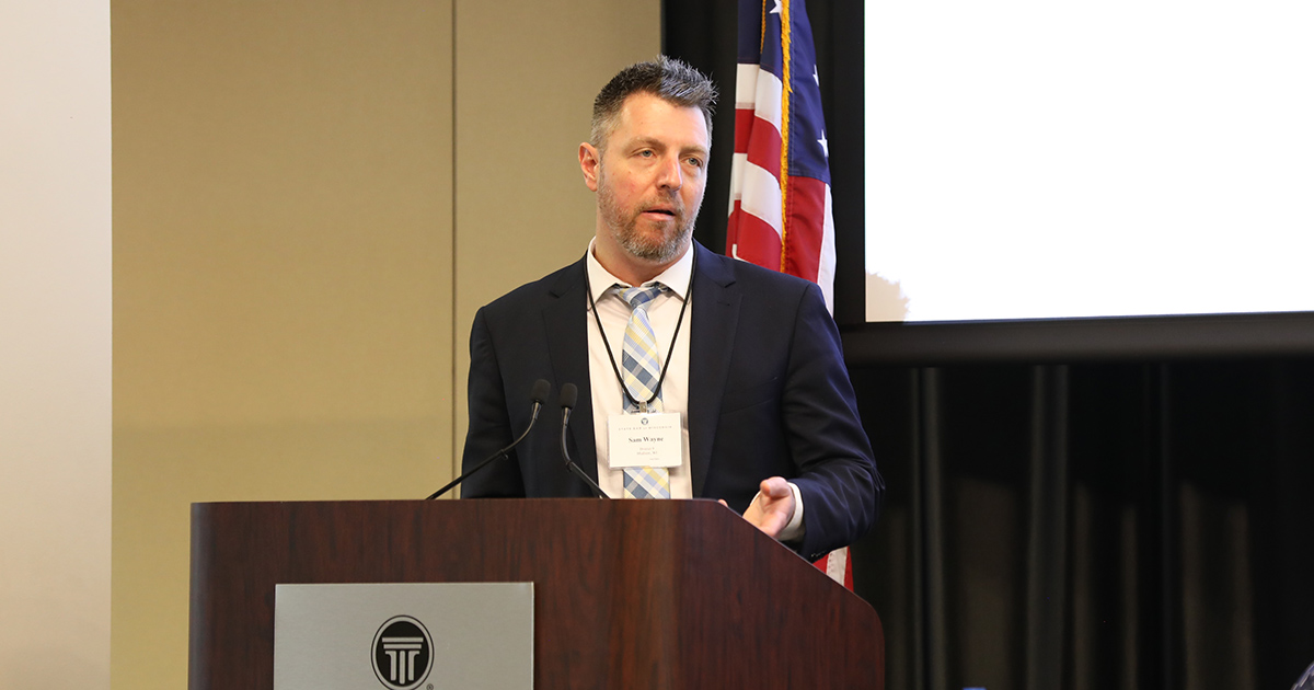a man speaking at a podium