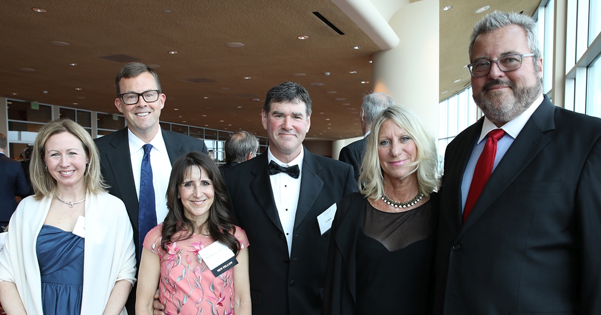 a group of six people smiling at the camera