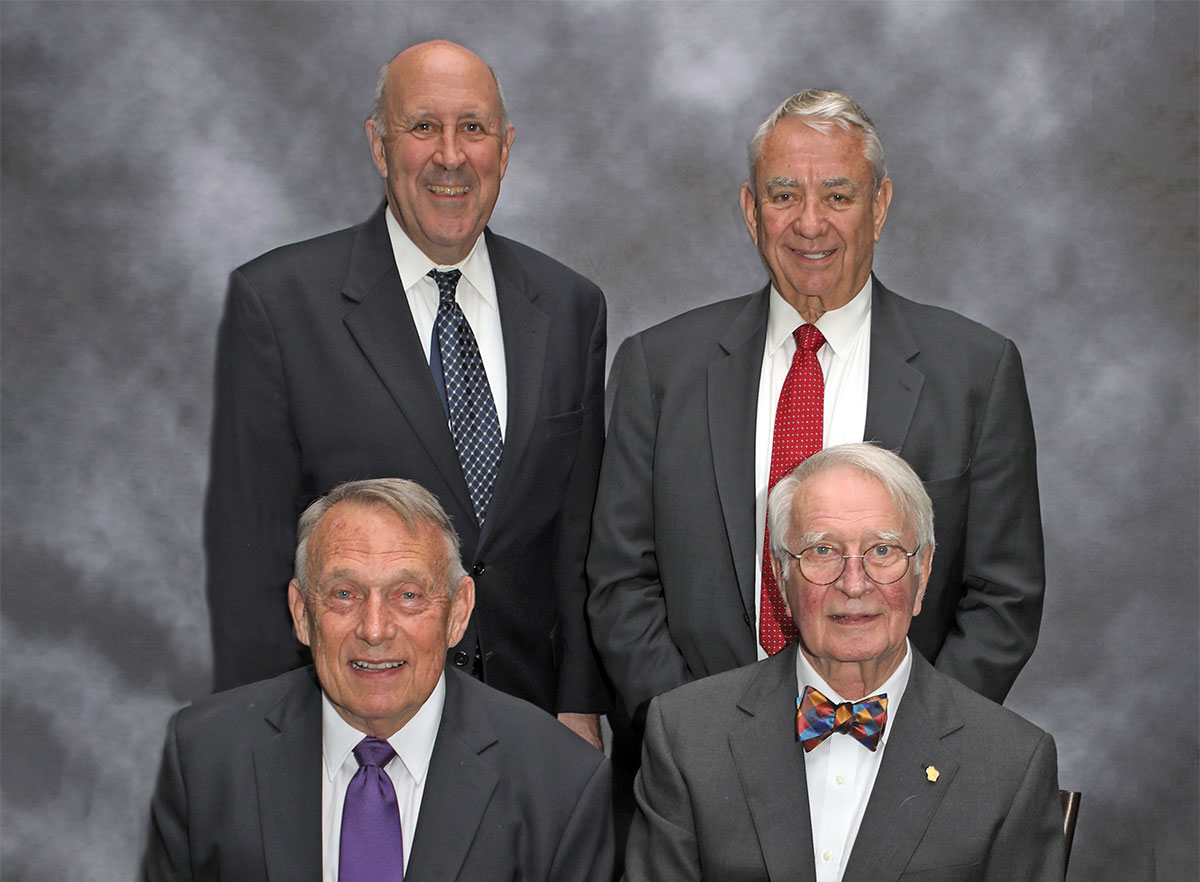 four award recipients with two seated and two standing