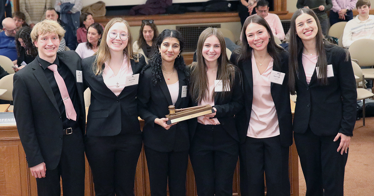 a group of people smile at the camera