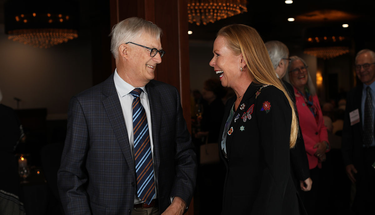Chief Justice Annette Kingsland Ziegler shares a laugh with 50-year member Mark Warpinski