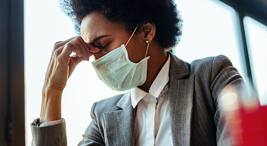 businesswoman in facemask looking ill