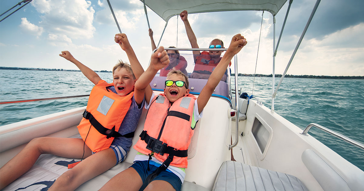 kids cheering on a boat