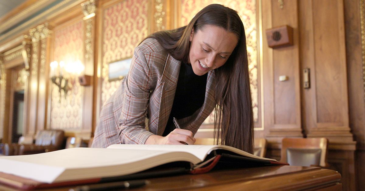 Nicolette Jordee signs the Supreme Court Roll Book