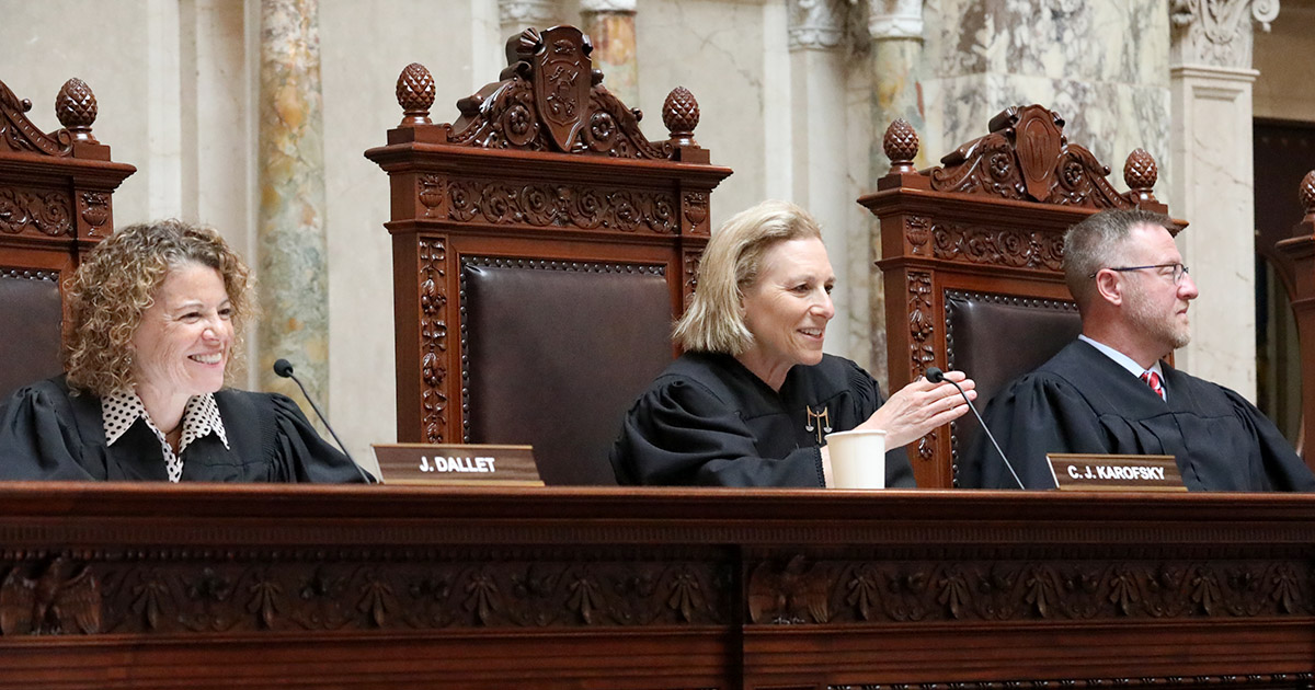 three people seated and smiling