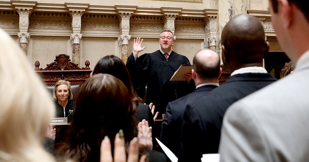 a group with hands raised for an oath