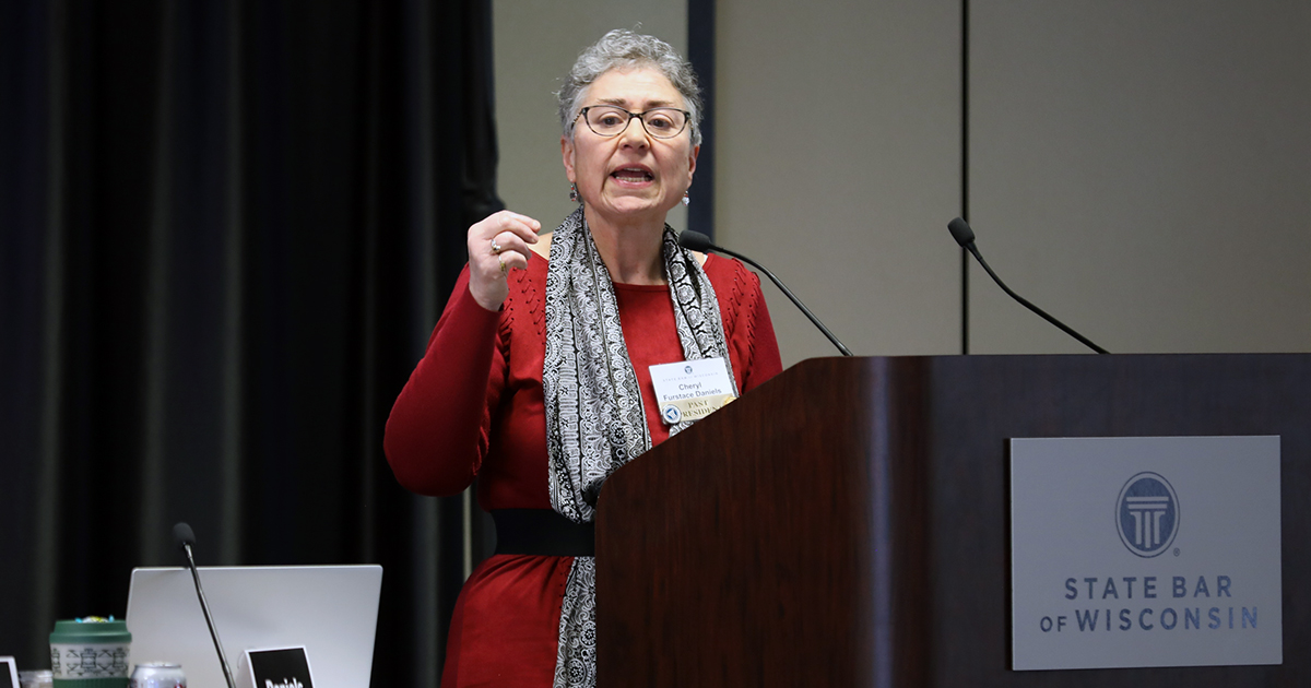 State Bar Past President Cheryl Daniels speaking at a podium