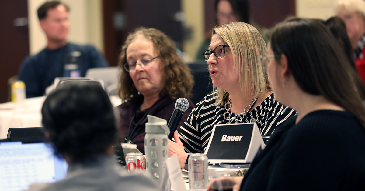 Karen Bauer speaks into a microphone