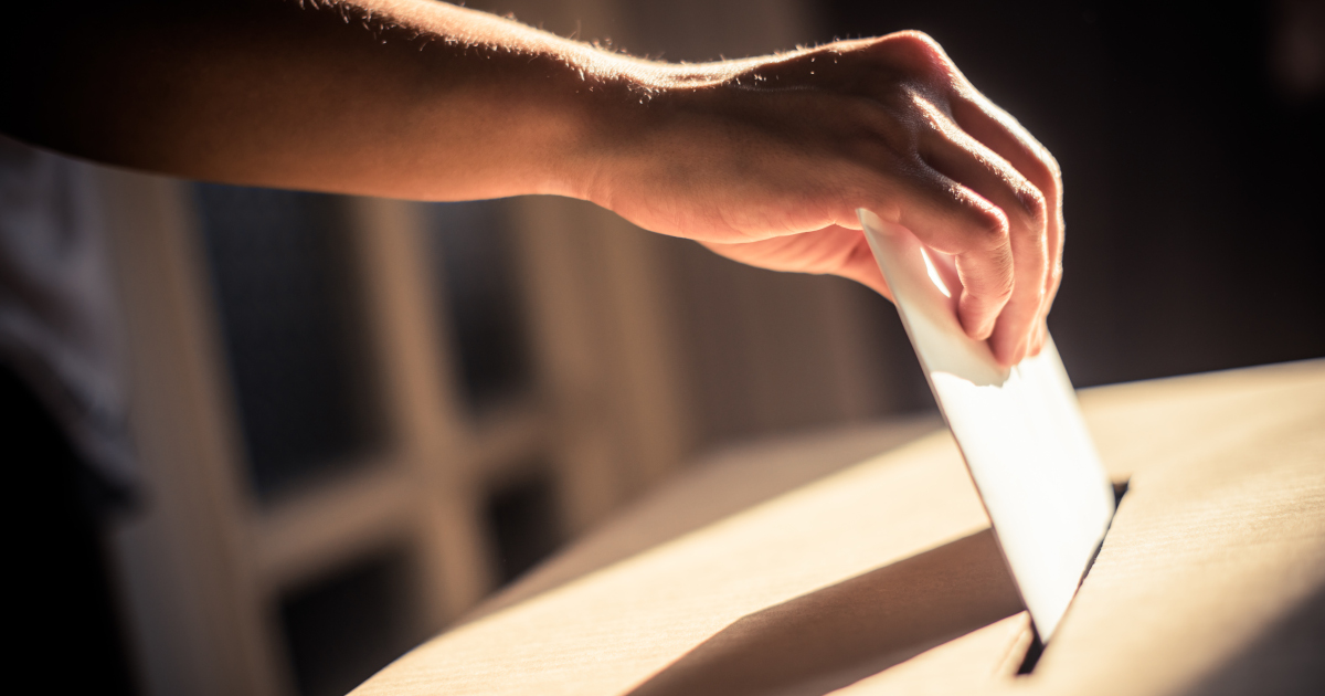 Man Placing A Ballot In A Ballot Box