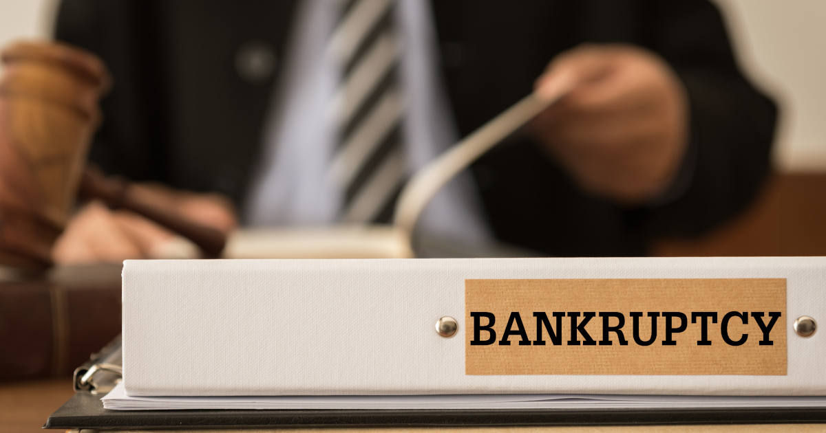 A Binder Labeled Bankruptcy Atop A Conference Table