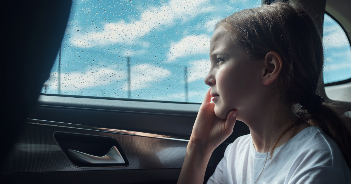 A Blonde Girl Staring Pensively Through A Modern Car’s Backseat Window