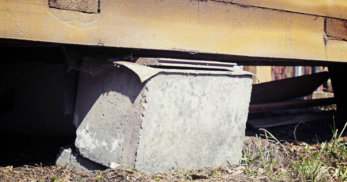 House Raised Off Its Foundation And Resting On A Cement Block