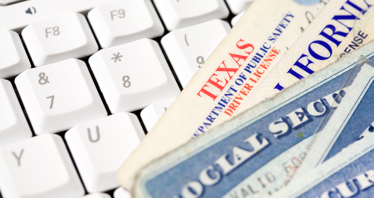 Drivers Licenses, One Each From Texas And California, Arrayed Like Playing Cards Across A Computer Keyboard