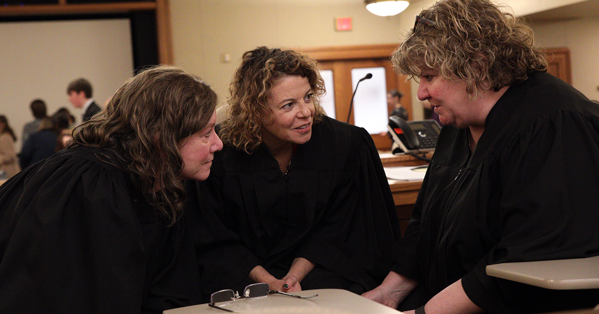 Finals judges confer after the round