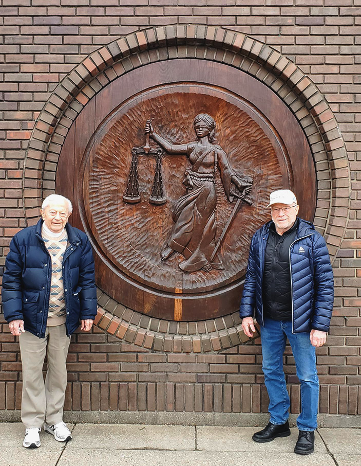 three people pose smiling and standing side by side