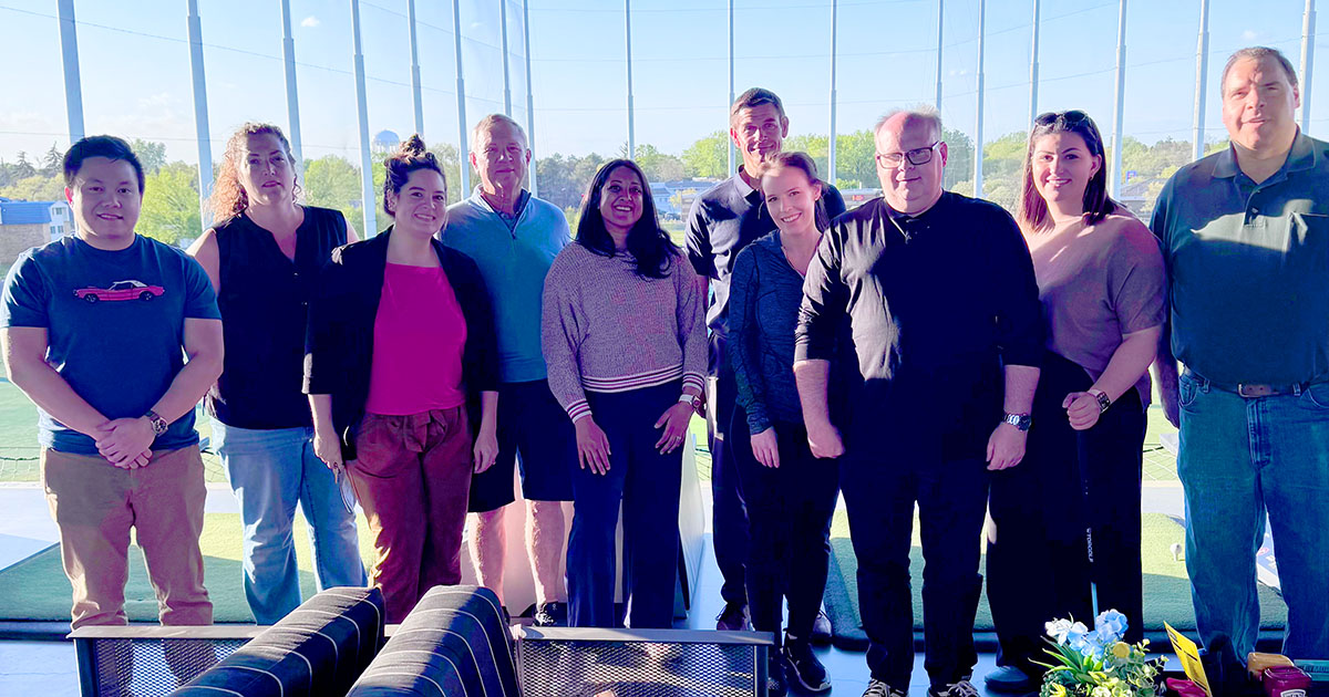 a large group of people smiling at the camera
