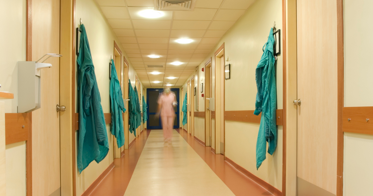 Nurse Walking Down The Hall Of A Nursing Home