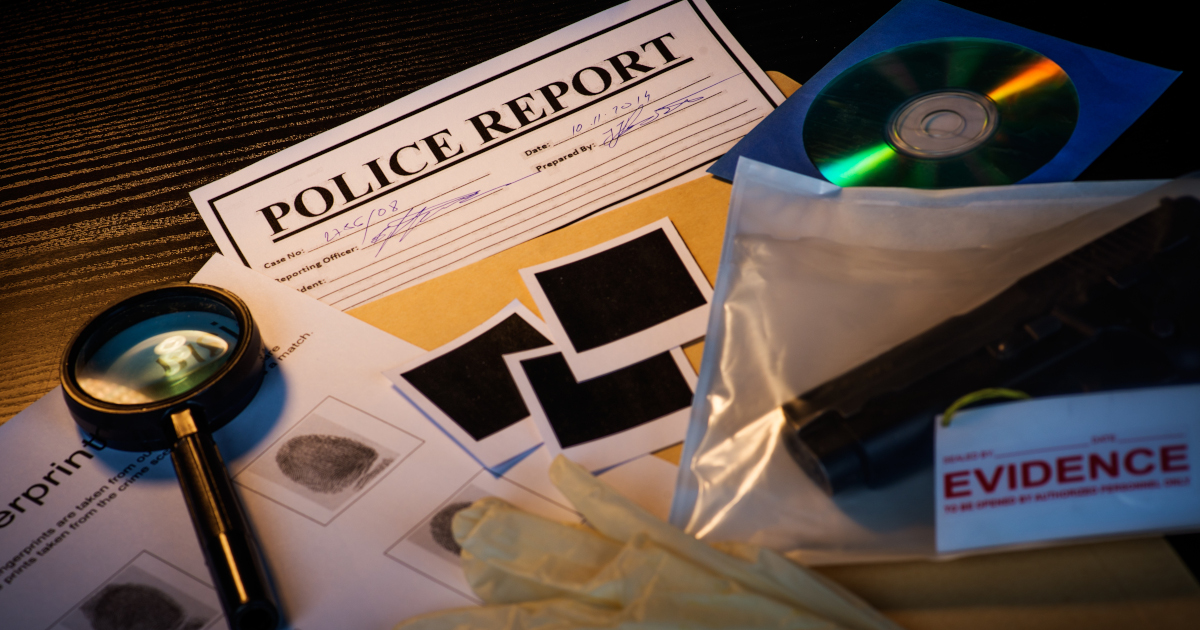 Police Report, Fingerprint Card, And Magnifying Glass