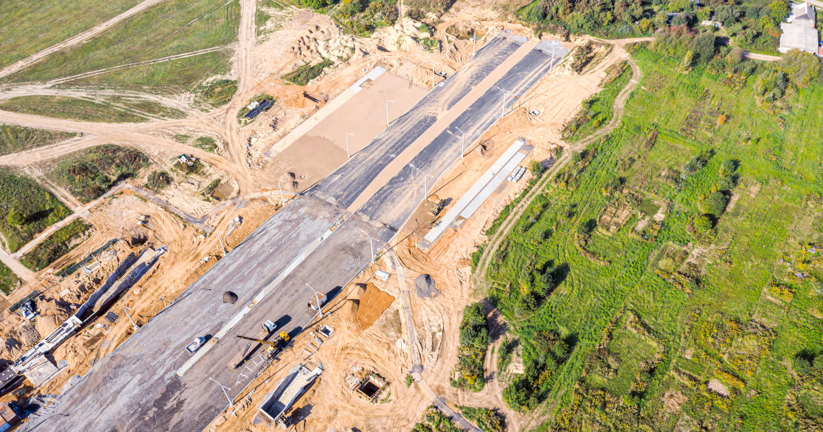 A Road Construction Site, Including A Stretch Of New Paved Roadways And Dirt Driveways, Viewed From The Air