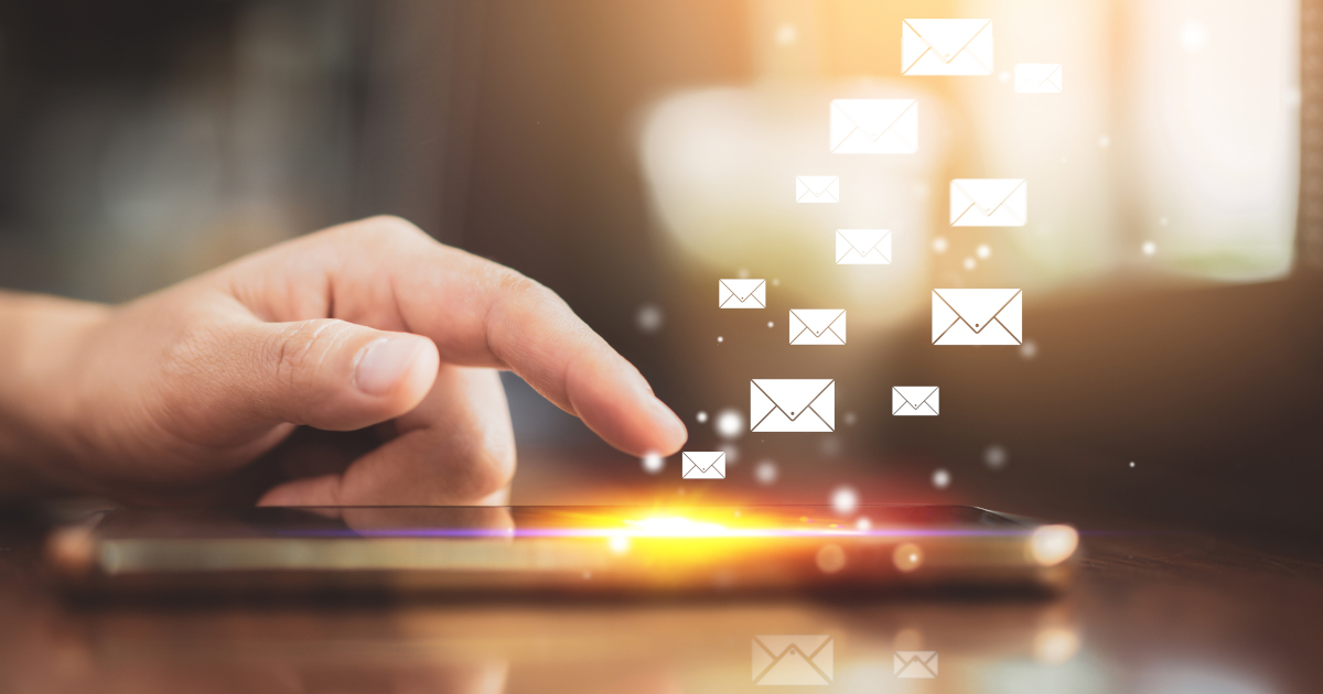 A Man’s Hand, With Index Finger Extended, Hovering Over A Tablet’s Touchscreen, As Email Icons Burst Up From The Tablet