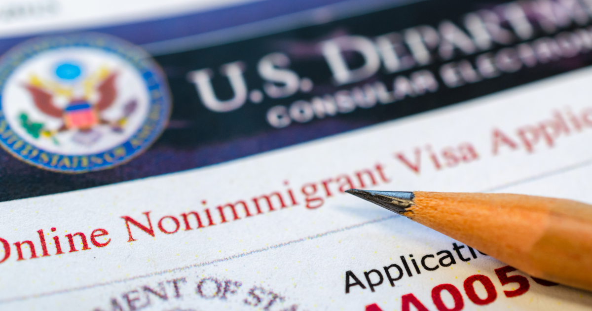 A Sharpened Pencil Lying Diagonally Across A U.S. Visa Application Form
