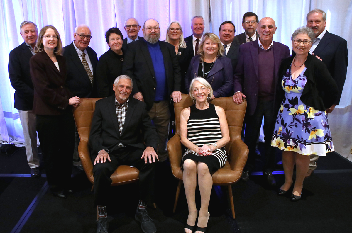 a group of smiling people on a stage