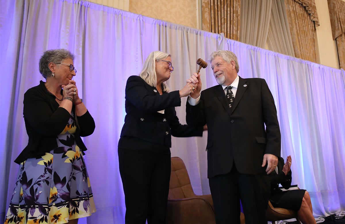 Margaret Hickey passes the gavel to Dean Dietrich