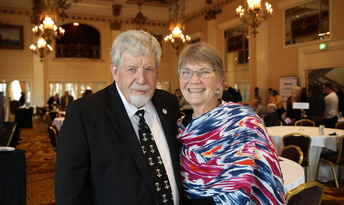 a man and woman smile at the camera