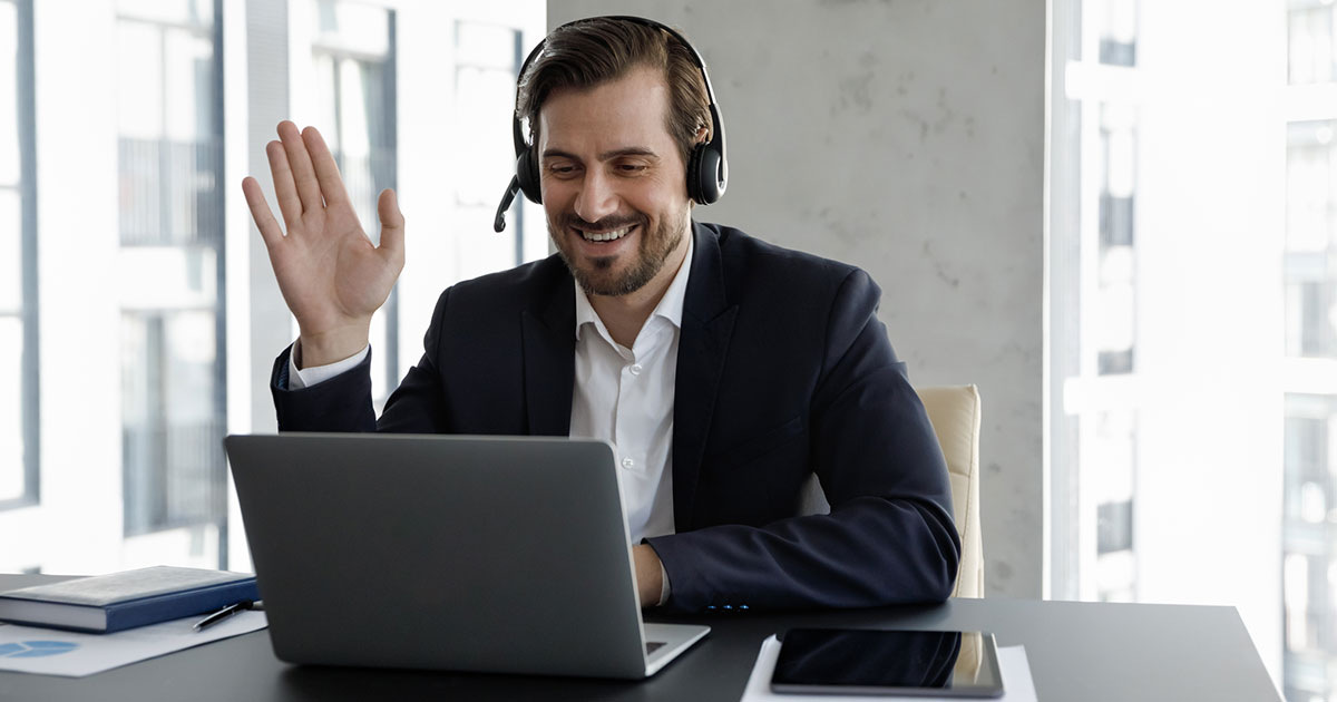 professional at desk with laptop on virtual meeting