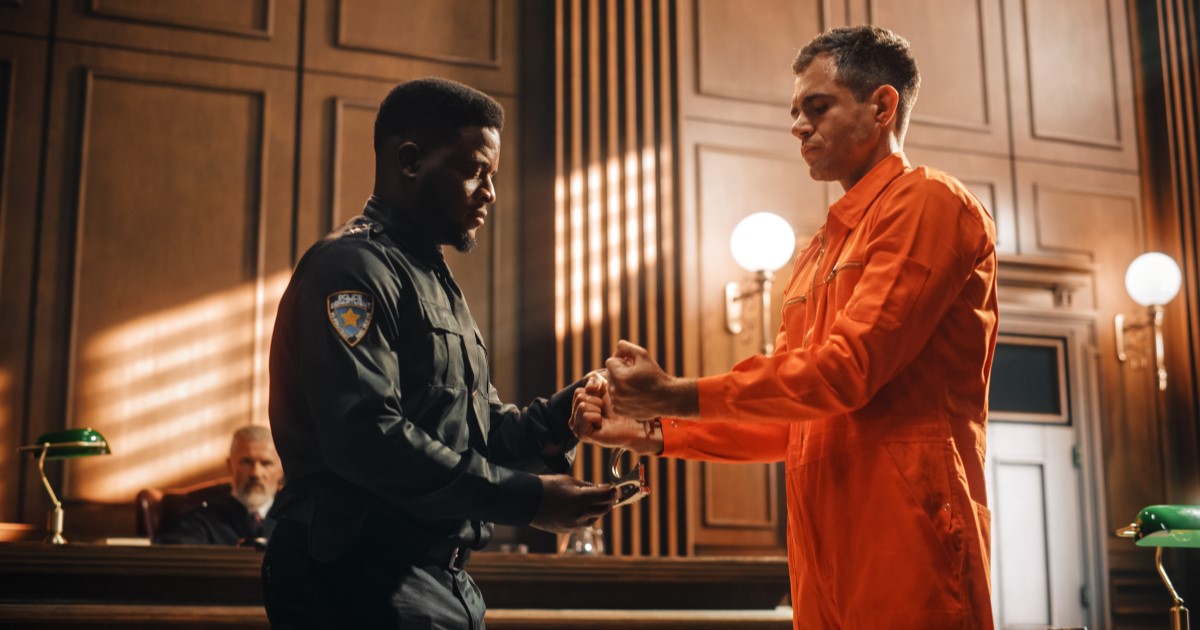 A man is handcuffed in a court room