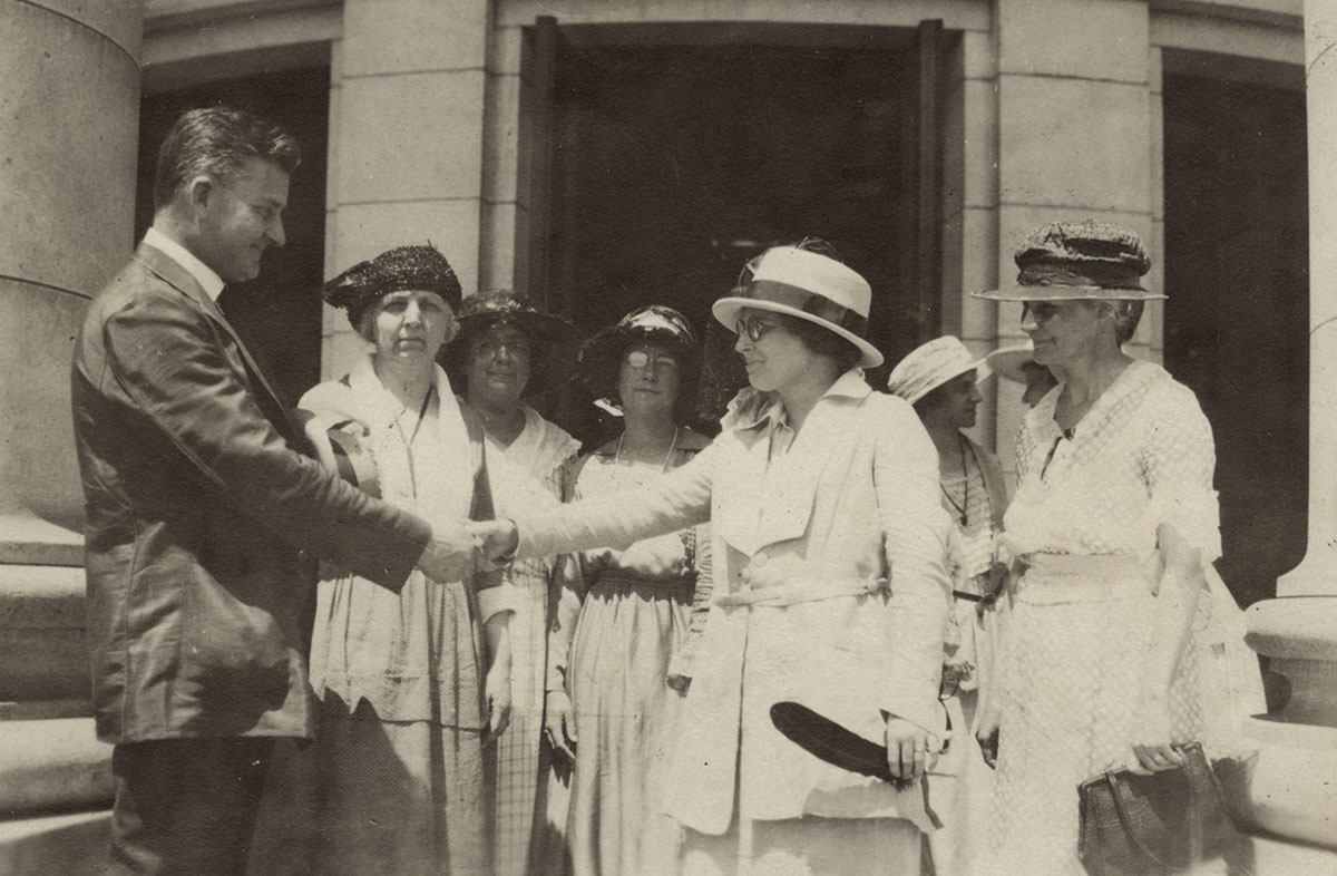 Gov. John J. Blain shakes the hand of Mabel Raef Putnam
