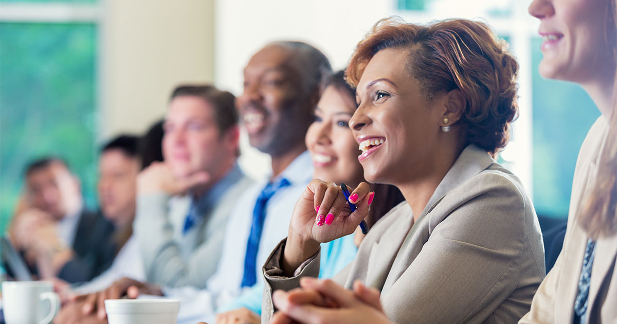 business woman smiling at conference table