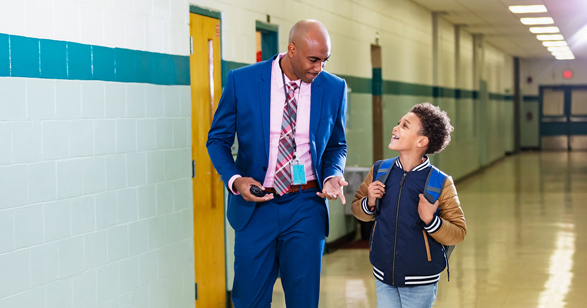 guardian walking with student at school