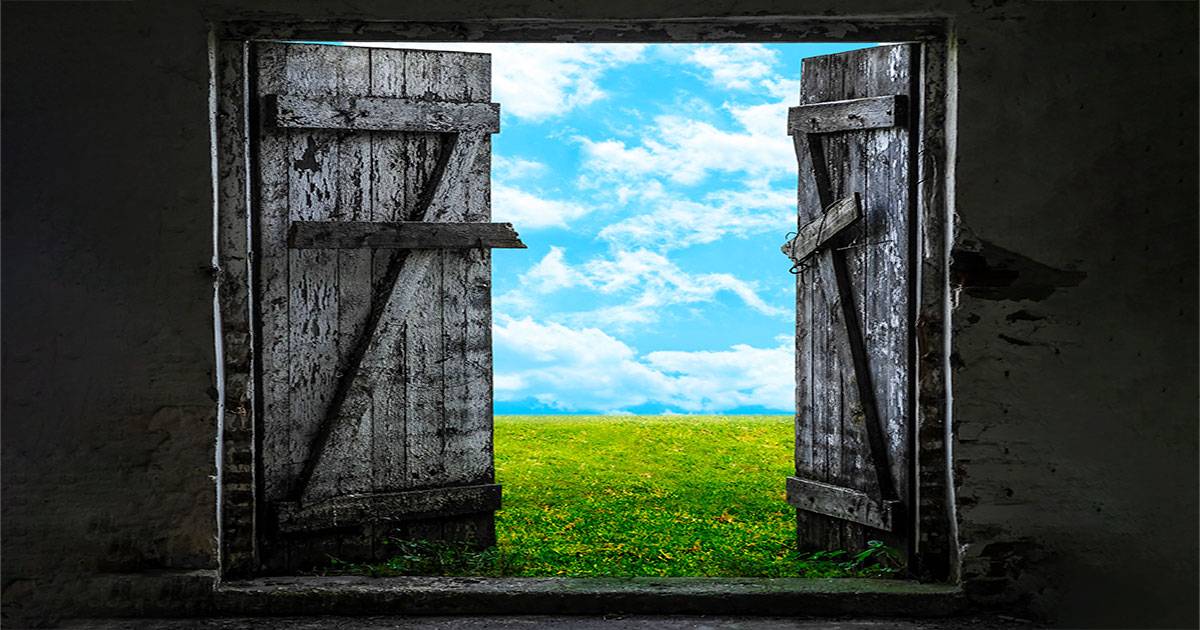 decrepit doors opening to a green field